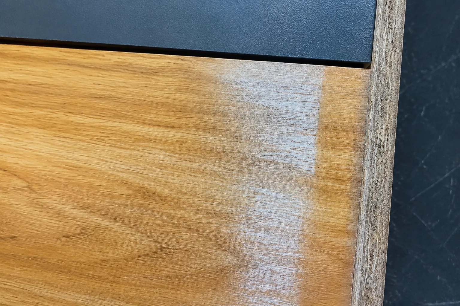 Close view of a marked material surface showing grain, coating, and placement context